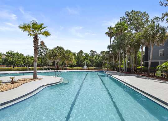 Community Swimming Pool with Pool Furniture at Mirage on Kernan Apartments located in Jacksonville, FL.