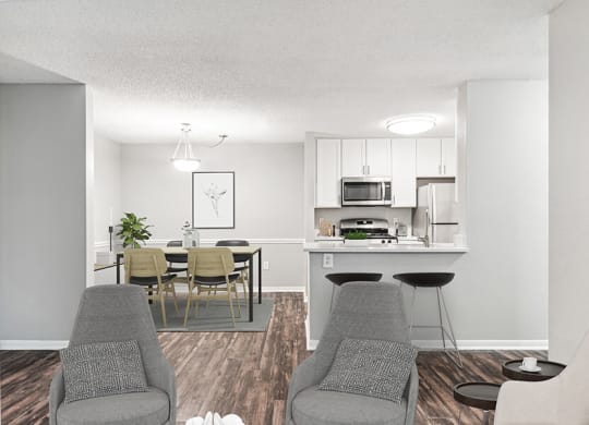 Model Living Room with Wood-Style Flooring and View of Kitchen/Dining Area at Commons at Haynes Farm Apartments in Shrewsbury, MA.
