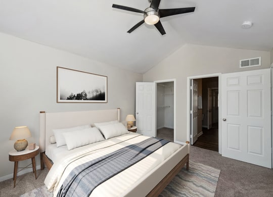 Model Bedroom with Carpet and Walk In Closet at Hidden Creek Apartments in Lewisville, TX.