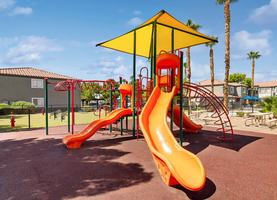 Community Playground with a Slide and Yellow Canopy at Loma Vista Apartments in Las Vegas, NV.