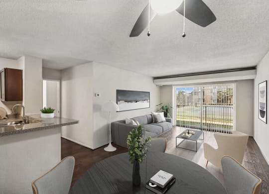 Model Dining Room with Wood-Style Flooring and View of Living Room with Patio Accessibility at Mason Van Dorn Apartments located in Alexandria, VA.