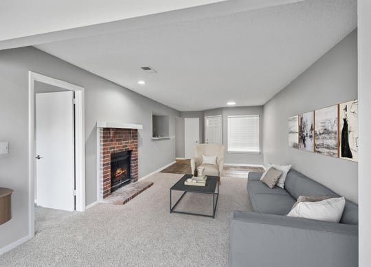 Model Living Room with Carpet and Patio Accessibility at Abbington Heights Apartments in Antioch, TN.