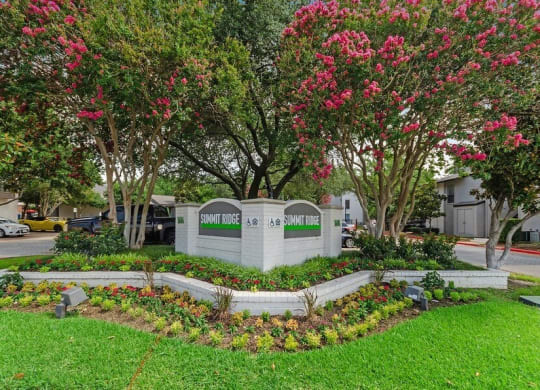 Property entrance sign showcasing well kept landscape