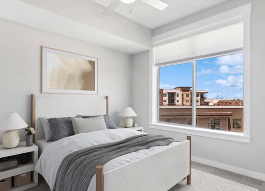Model Bedroom with Carpet and Window View at Seven Skies Apartments located in Sandy, UT.