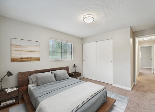 Model Bedroom with Carpet and Closet at Grammercy Apartments located in Renton, WA.