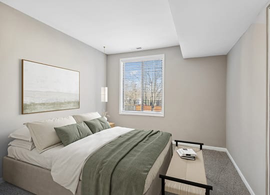 Model Bedroom with Carpet and Window View at Spring Parc Apartments in Silver Spring, MD.