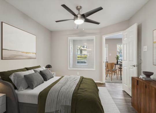 a bedroom with a large bed and a ceiling fan