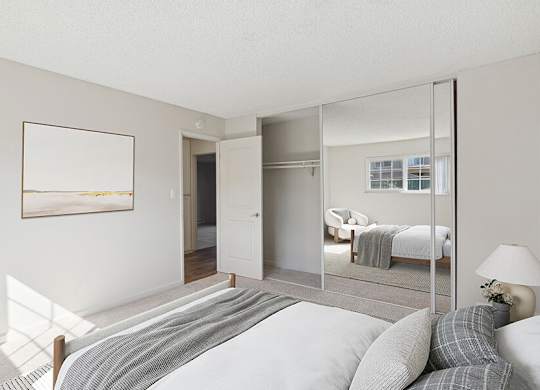 Model Bedroom with Carpet and Large Closet at Los Gatos Landing Apartments located in San Jose, CA.