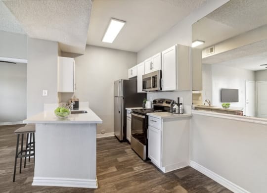 a kitchen with a stove top oven next to a refrigerator