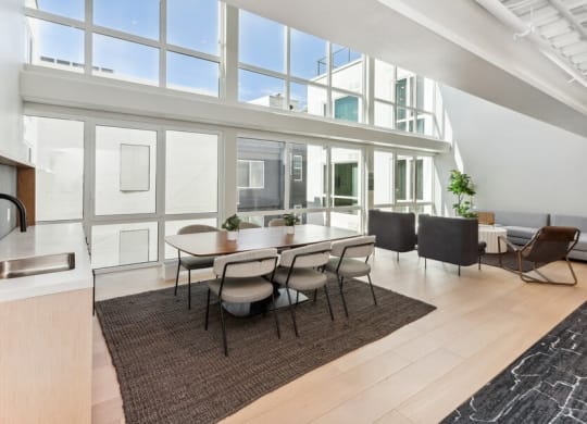 Community kitchen space with large sun windows at TL Residences