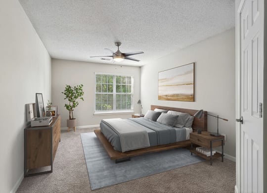 Model Bedroom with Carpet and Window View at Retreat at Stonecrest Apartments located in Lithonia, GA.
