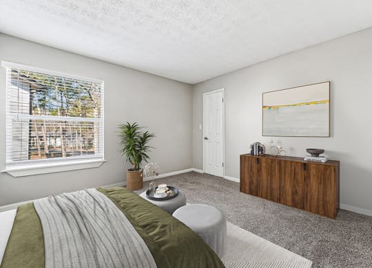 Model Bedroom with Carpet and Window View at Paramont Apartments in Duluth, GA.