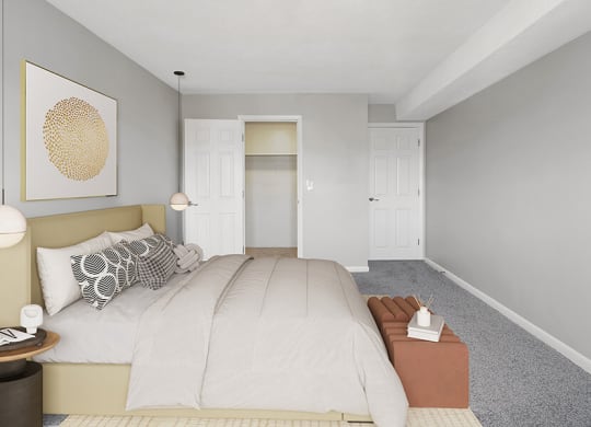Model Bedroom with Carpet & Walk In Closet at Stone Ends Apartments in Stoughton, MA.