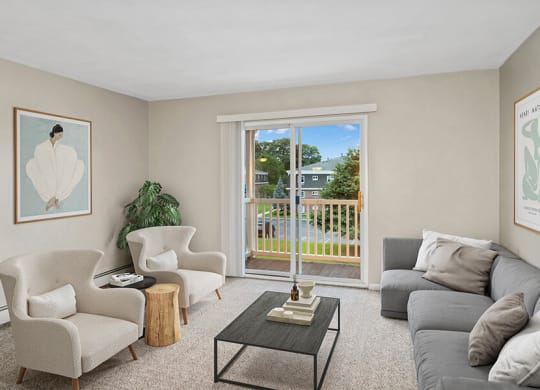 Model living room with a sliding glass door  at Stone Ends apartments in Stoughton, MA