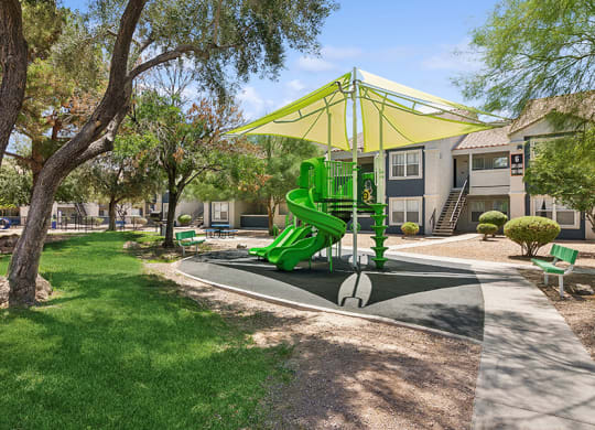 Community Playground with a Slide and Yellow Canopy at Monterra Apartments located in Las Vegas, NV.