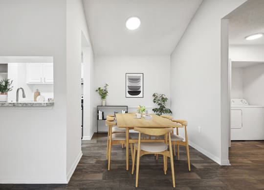 Model Dining Room and Kitchen with Wood-Style Flooring at Rosehill Preserve Apartments located in Orlando, FL.
