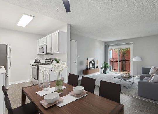 Model Living Room with Wood-Style Flooring and View of Kitchen/Living Room Area at The Archer Apartments in Sacramento, CA.