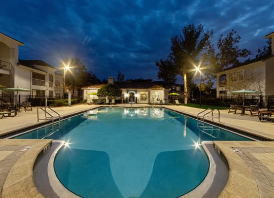 Community Swimming Pool with Pool Furniture at Vinings at Hunter's Green Apartments in Tampa, FL.