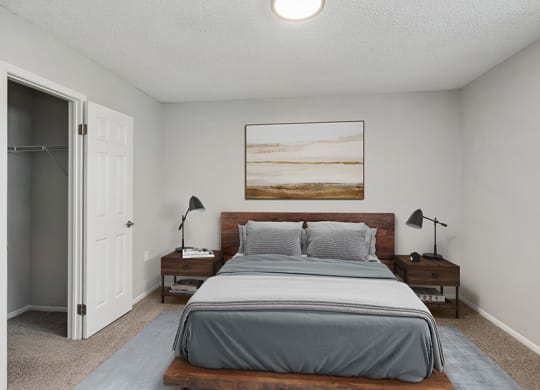 Model Bedroom with Carpet and Closet at Parc at Creekside Apartments in Kansas City, MO.