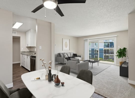 Model kitchen and living room with a ceiling fan
