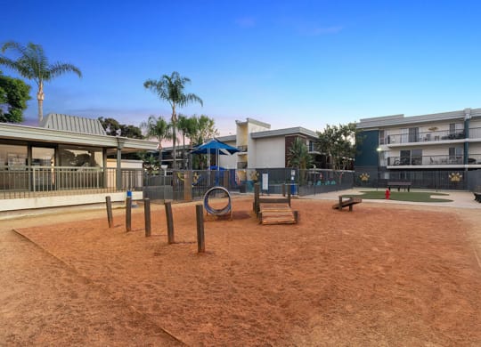 Community Dog Park with Agility Equipment at Madison Park Apartments located in Anaheim, CA.