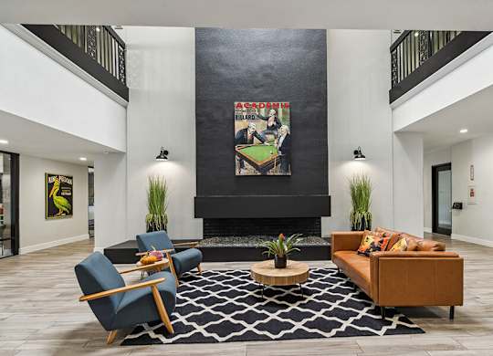 Community Clubhouse with Lounge Furniture and Fireplace at Madison Park Apartments located in Anaheim, CA.