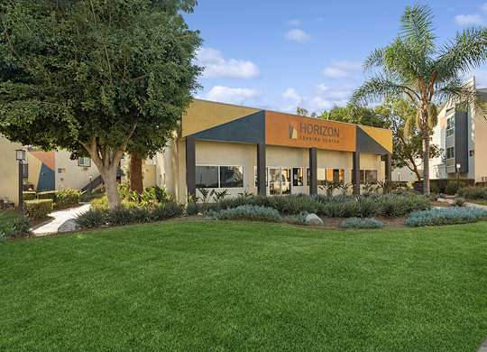 Exterior Community Building and Landscape at Horizon Apartments located in Santa Ana, CA.