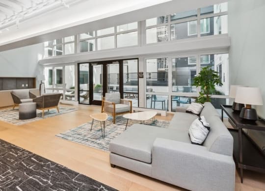 Interior lounge with large sun windows at TL Residences