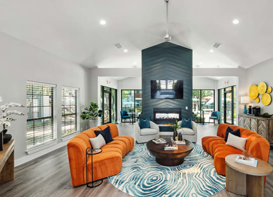 Community Clubhouse with Lounge Furniture and Fireplace at Bridges at Deer Run Apartments in Dallas, TX.