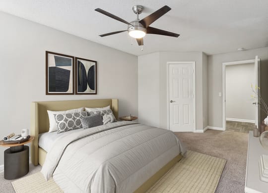 Model Bedroom with Carpet and Hallway View at Retreat at Stonecrest Apartments located in Lithonia, GA.