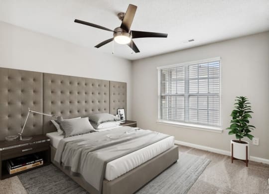 Model bedroom with ceiling fan at Retreat at Stonecrest Apartments