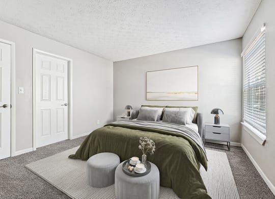 Model Bedroom with Carpet and Window View at Paramont Apartments in Duluth, GA.