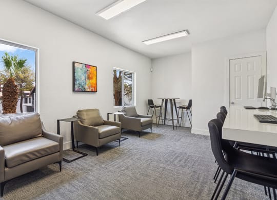 Community Clubhouse with Lounge Furniture and Work Stations at Meadow Ridge Apartments located in Las Vegas, NV.