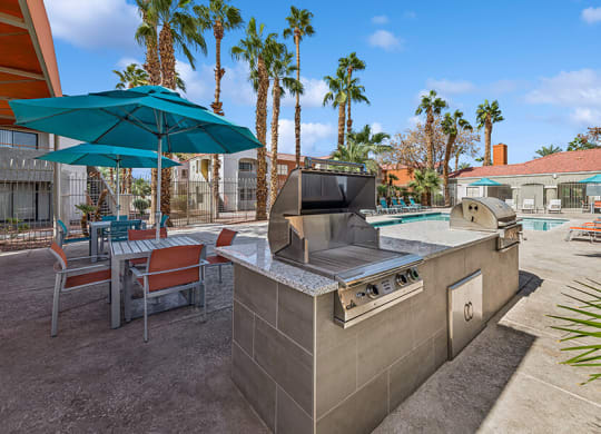 Outdoor BBQ Area with Picnic Tables at Stonegate Apartments located in Las Vegas, NV.