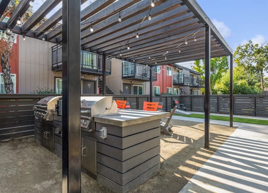 Outdoor BBQ Area with Furniture at The Archer Apartments in Sacramento, CA.