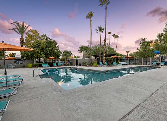 Community Swimming Pool with Pool Furniture at Lakeside Casitas Apartments located in Tucson, AZ.