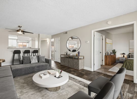 Model apartment living room with a couch a coffee table and a kitchen at Villages at Metro Center, Phoenix, 85051