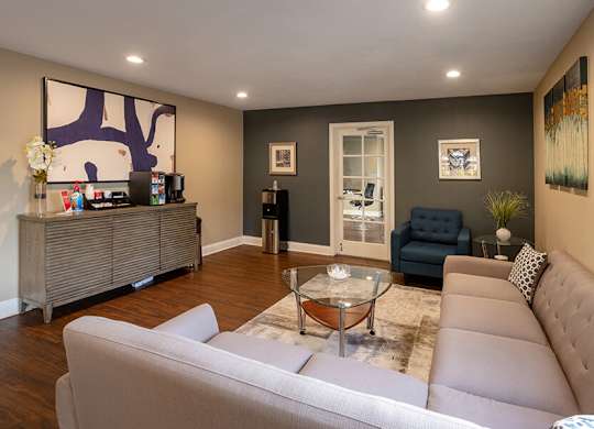 Community Clubhouse with Lounge Chairs and Coffee Bar at Santa Fe Ranch Apartments located in Carlsbad, CA.