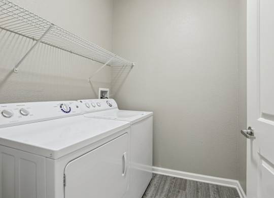 Model laundry room with a white washer and dryer.