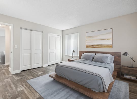 Model Bedroom with Wood-Style Flooring and attached Bathroom at Peaks on 4th Apartments in Avondale, AZ.