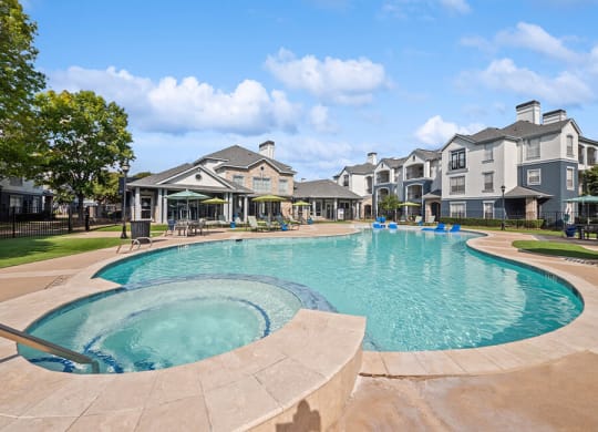 Community Swimming Pool and Hot Tub at Park West Apartments located in Houston, TX.