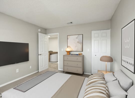 Model bedroom with a bed and a dresser
