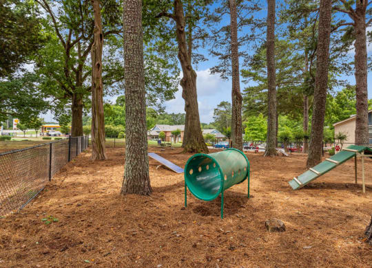 a playground with a slide and a seesaw in a park