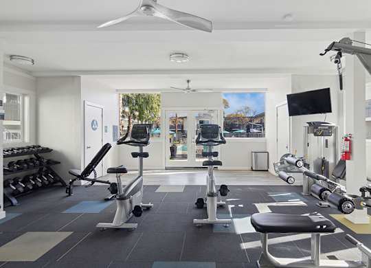 Community Fitness Center with Equipment at Los Gatos Landing Apartments located in San Jose, CA.