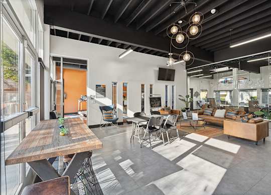 Community Clubhouse with Lounge Furniture and TV at Horizon Apartments located in Santa Ana, CA.