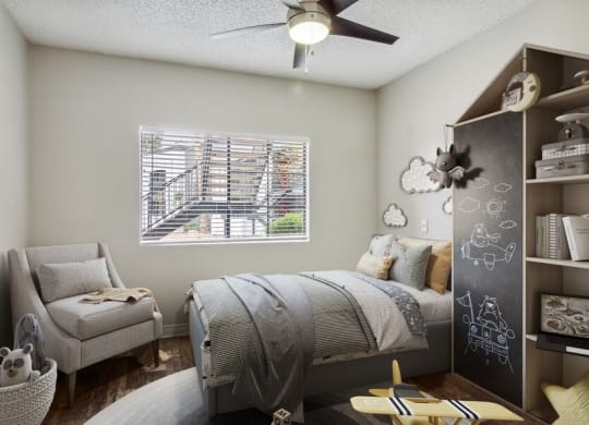 a bedroom with a bed and a chair in front of a window