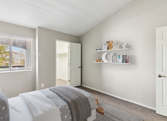 Model Bedroom with Carpet & Walk in Closet at Verraso Apartments in Las Vegas, NV.