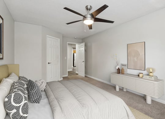 Model Bedroom with Carpet and Hallway View at Retreat at Stonecrest Apartments located in Lithonia, GA.