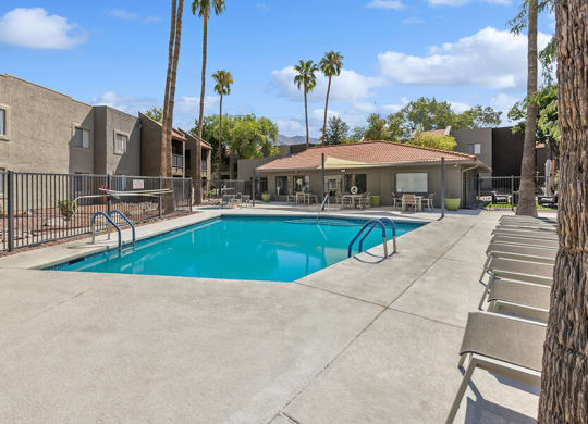 Community Swimming Pool with Pool Furniture at Saddle Ridge Apartments in Tucson, AZ.