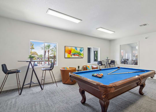 Community Clubhouse with Game Tables and Lounge Furniture at Meadow Ridge Apartments located in Las Vegas, NV.